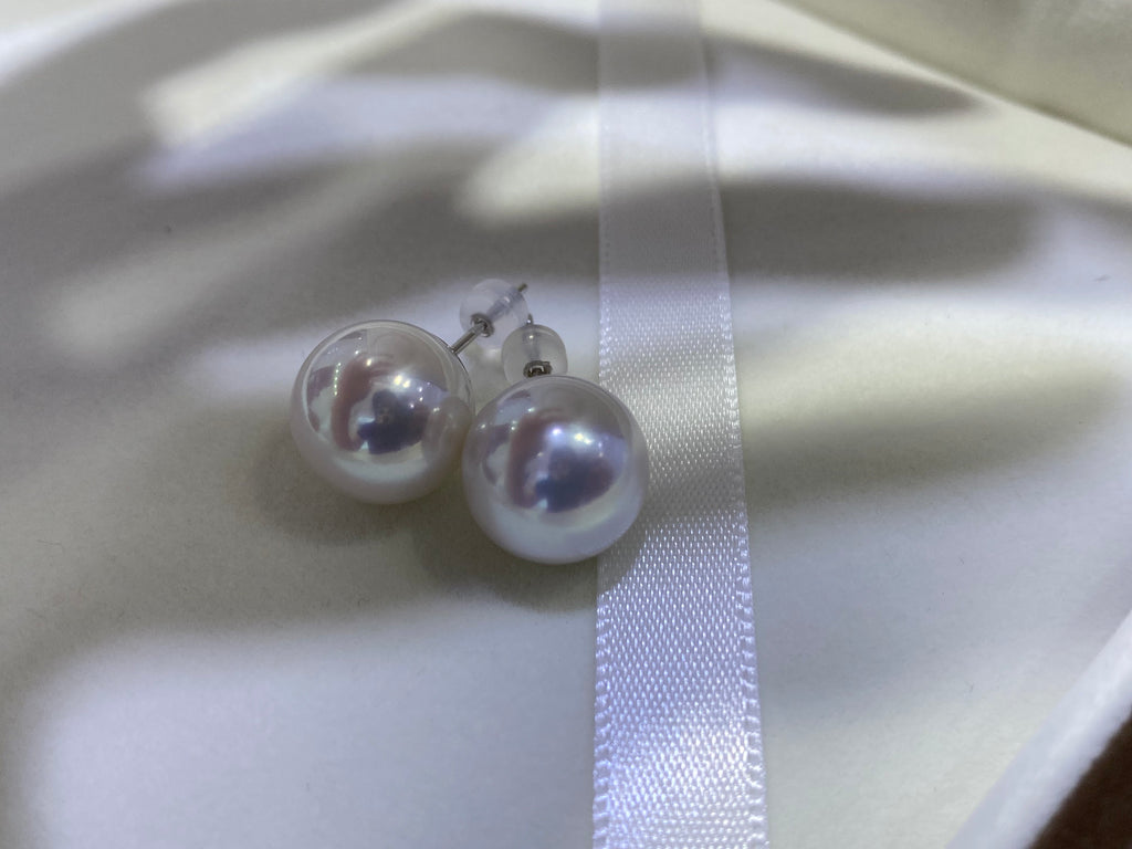 Pair of round white 10–11mm freshwater pearl stud earrings with 18K gold posts