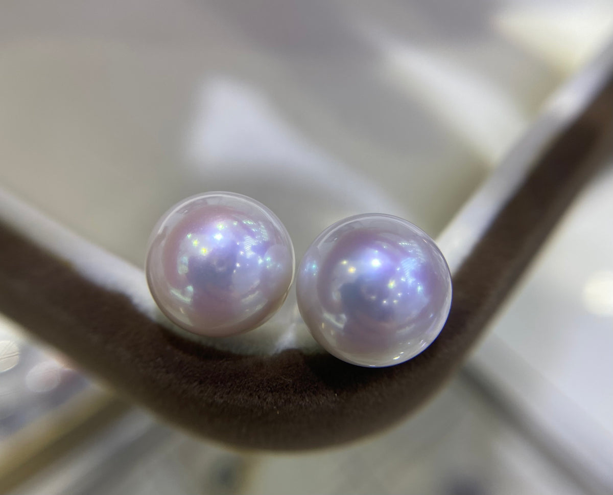 Pair of round white 10–11mm freshwater pearl stud earrings with 18K gold posts