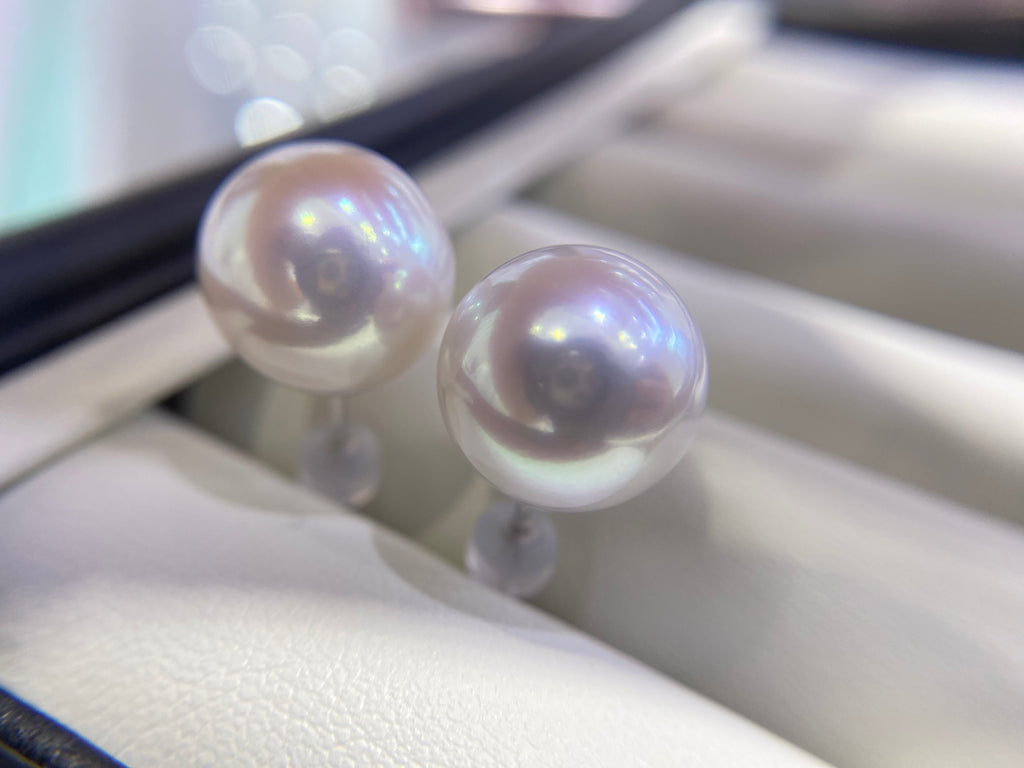 Pair of round white 10–11mm freshwater pearl stud earrings with 18K gold posts