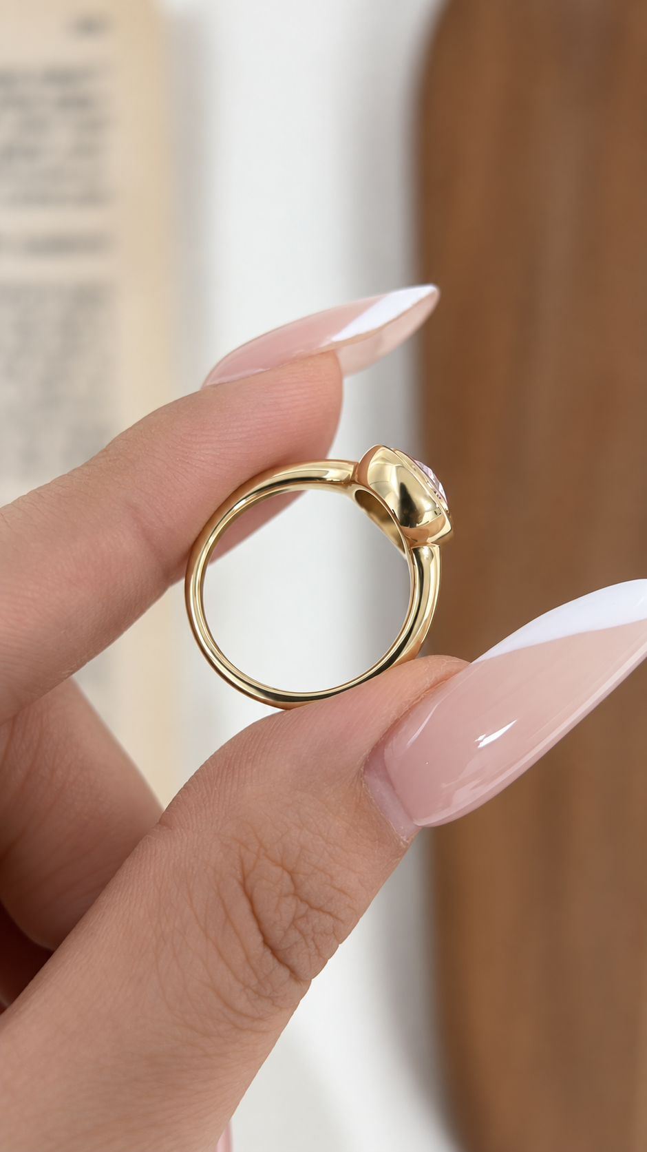 Side profile of yellow gold oval bezel solitaire ring