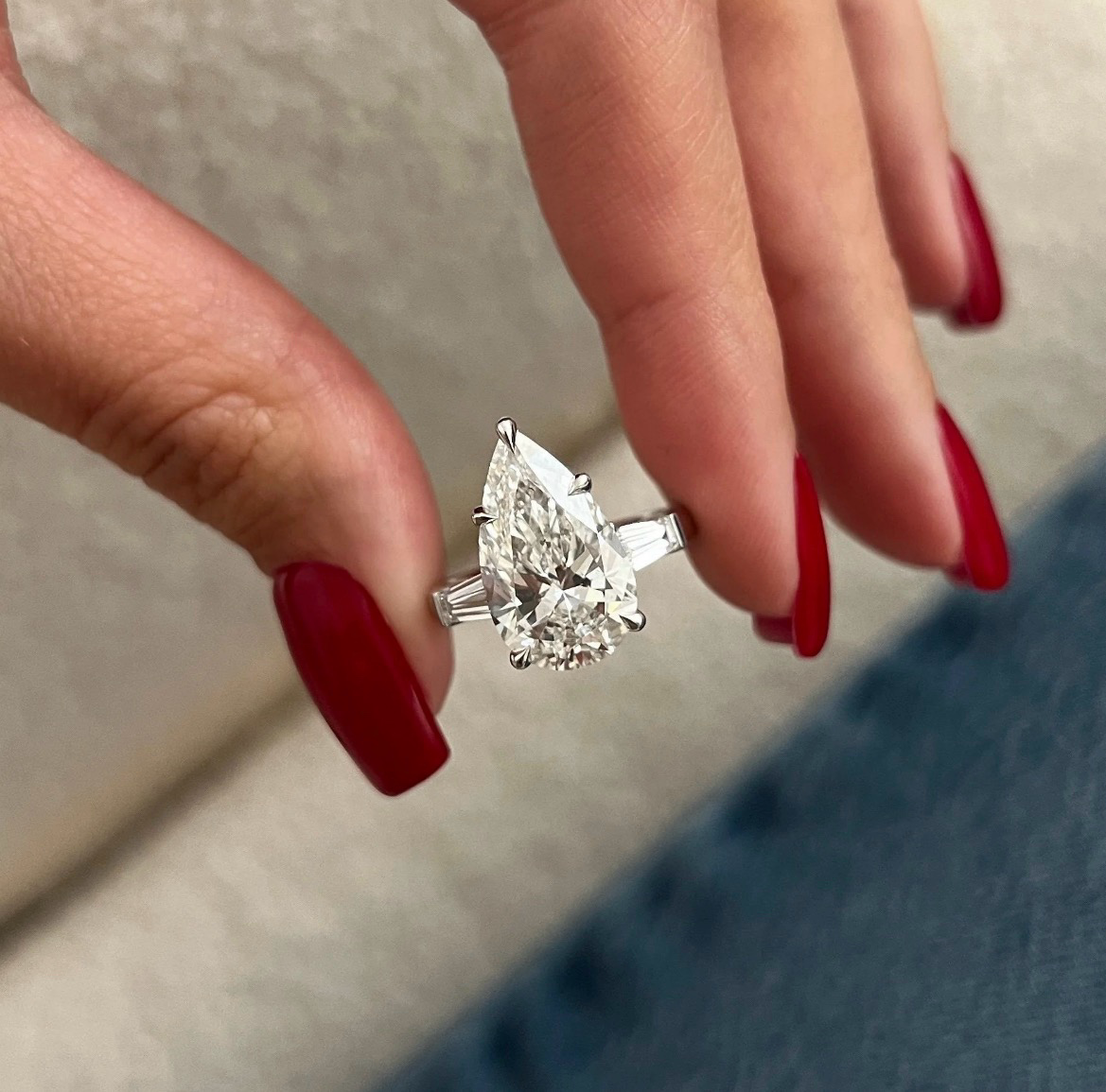 Pear-shaped diamond ring with tapered baguette side stones in platinum