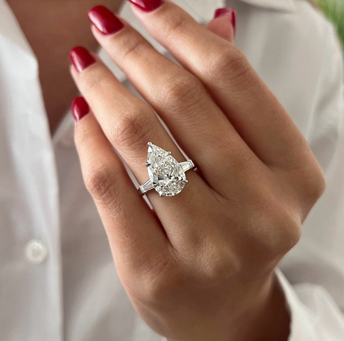 Pear-shaped diamond ring with tapered baguette side stones in platinum