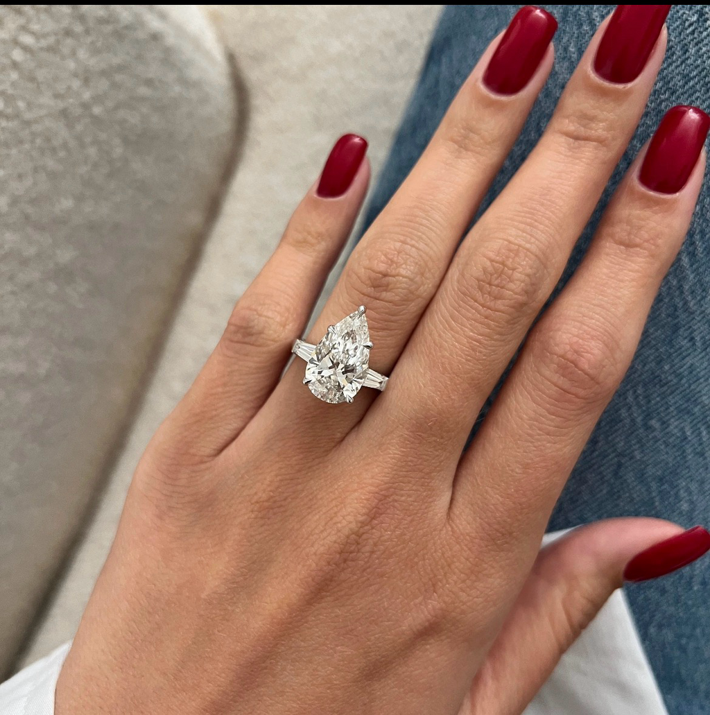 5ct pear-shaped diamond trilogy ring in platinum, worn on hand