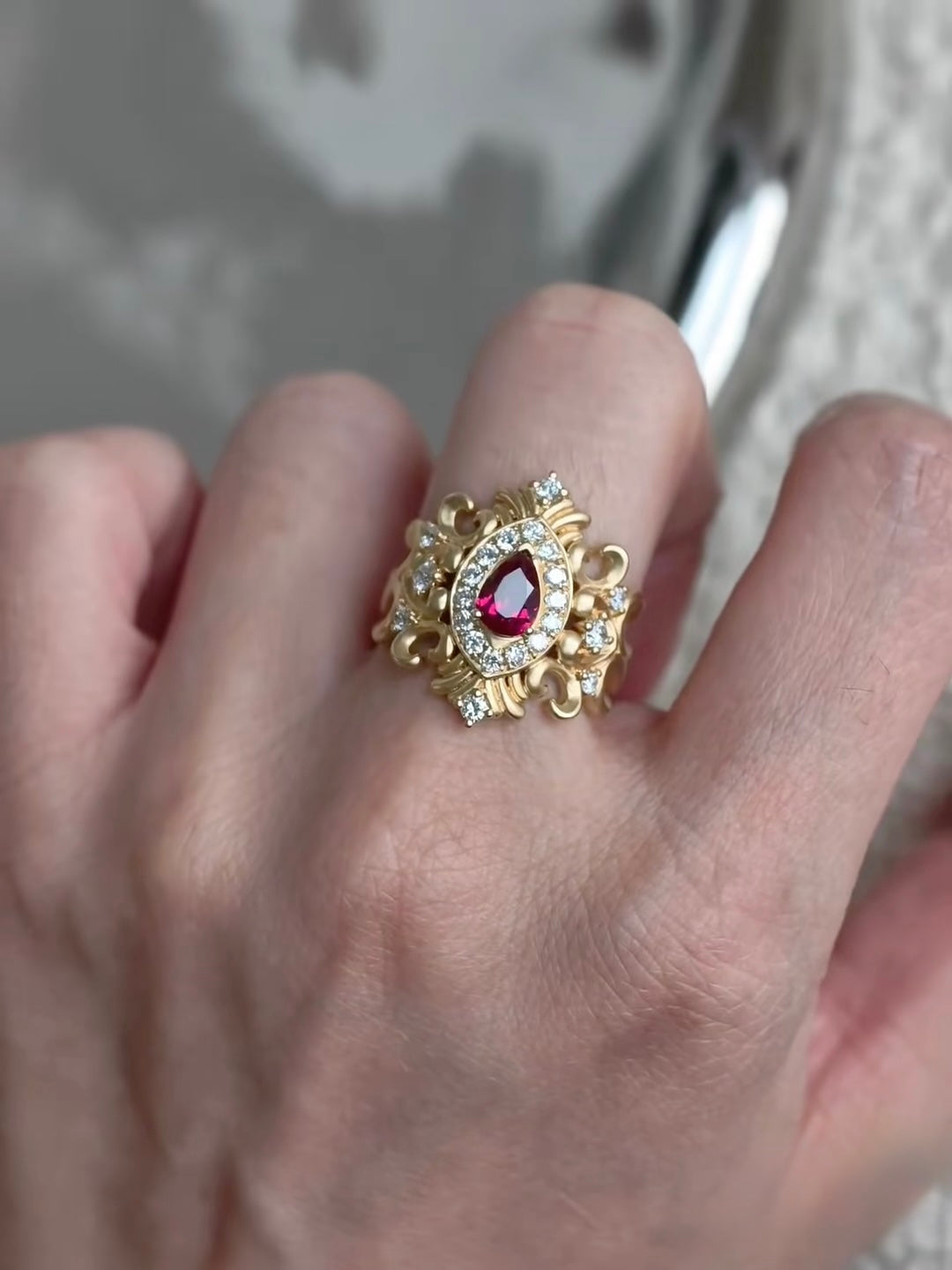 Bespoke 18K yellow gold pear ruby ring with ornate scrollwork and lab-grown diamonds