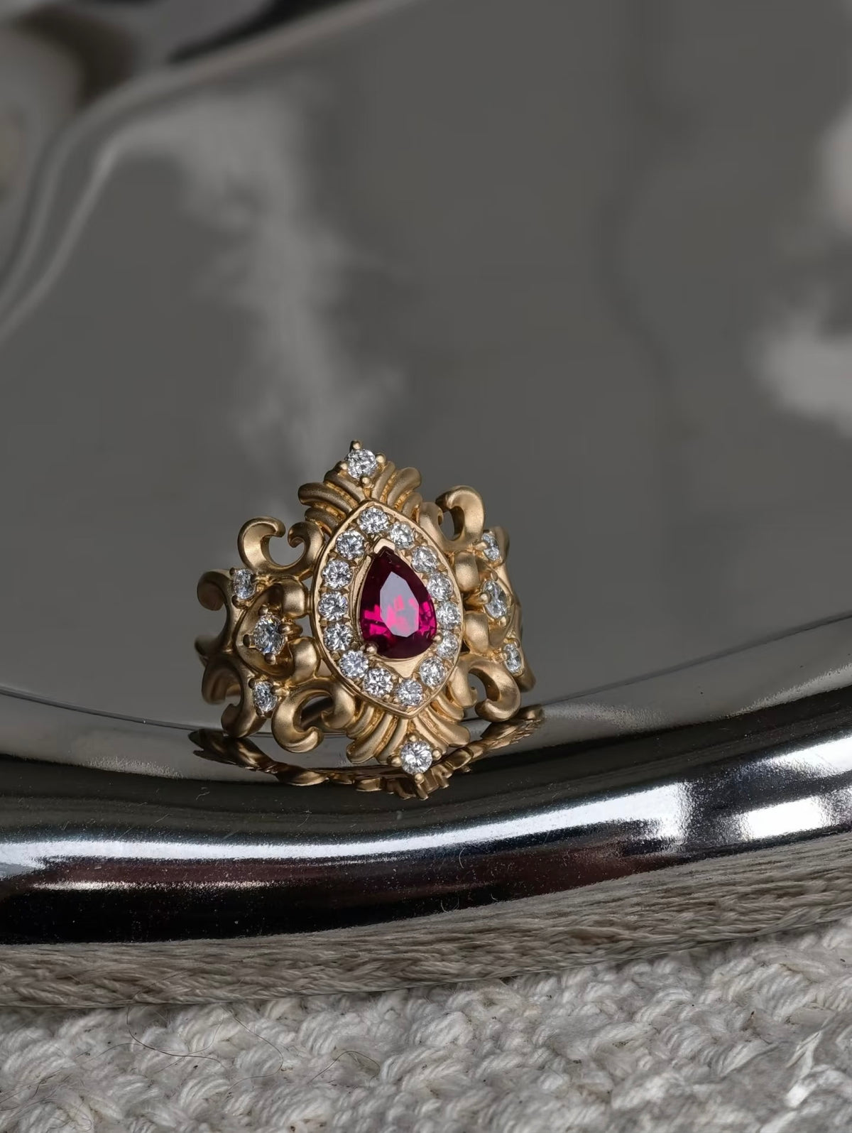 Bespoke 18K yellow gold pear ruby ring with ornate scrollwork and lab-grown diamonds