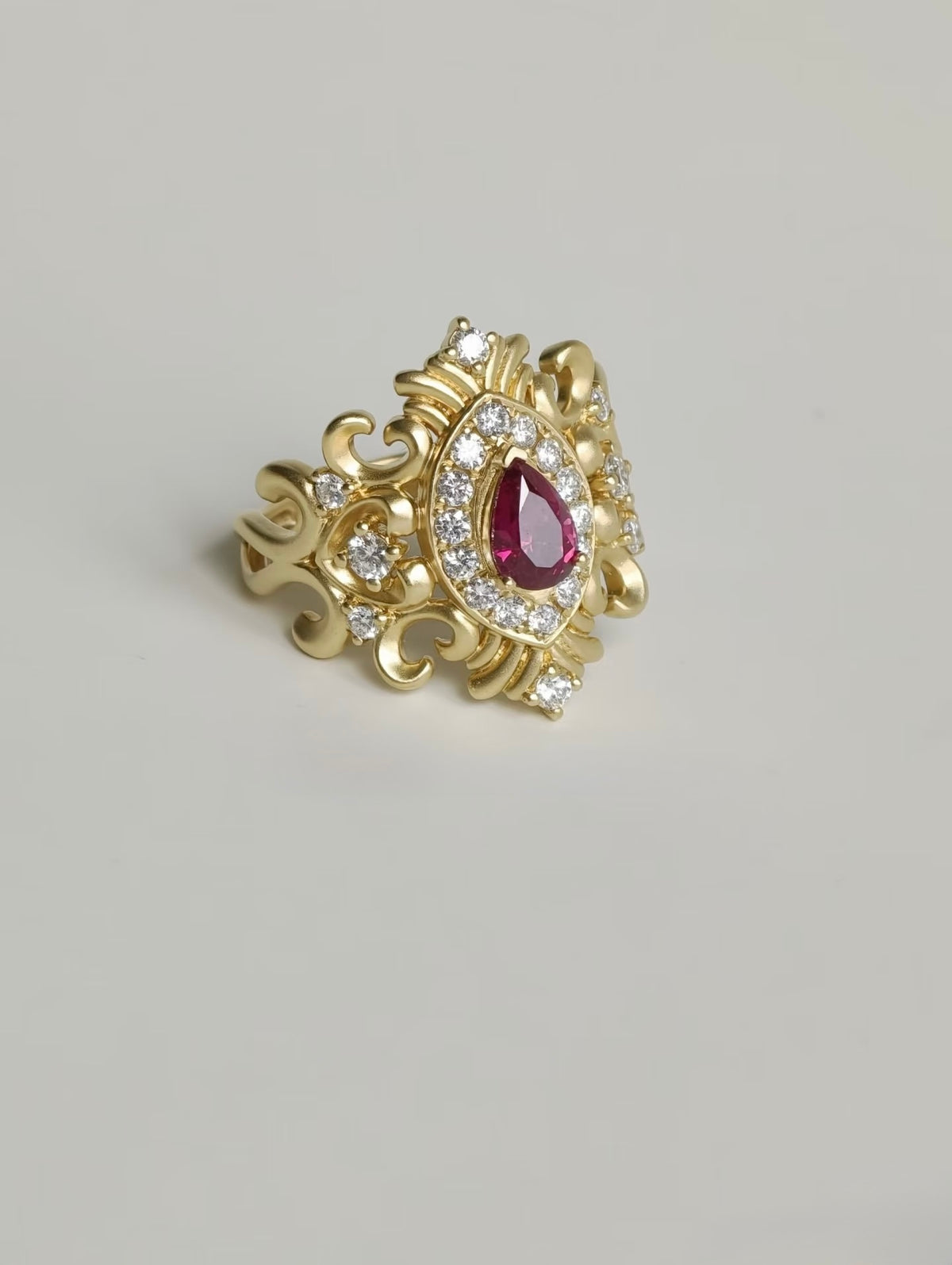 Bespoke 18K yellow gold pear ruby ring with ornate scrollwork and lab-grown diamonds
