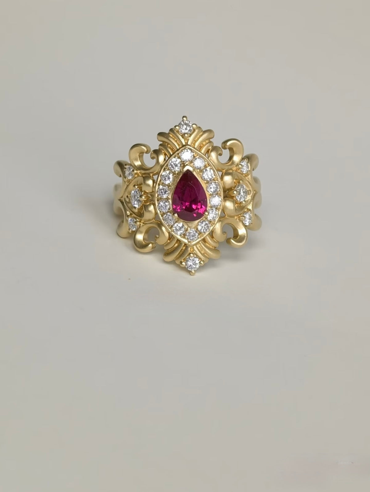 Bespoke 18K yellow gold pear ruby ring with ornate scrollwork and lab-grown diamonds
