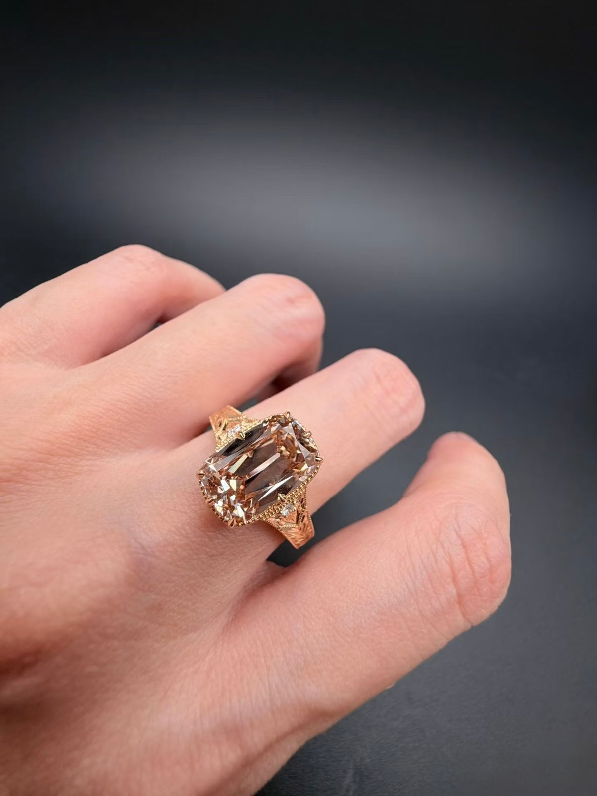On-hand view of champagne elongated cushion lab-grown diamond ring in yellow gold