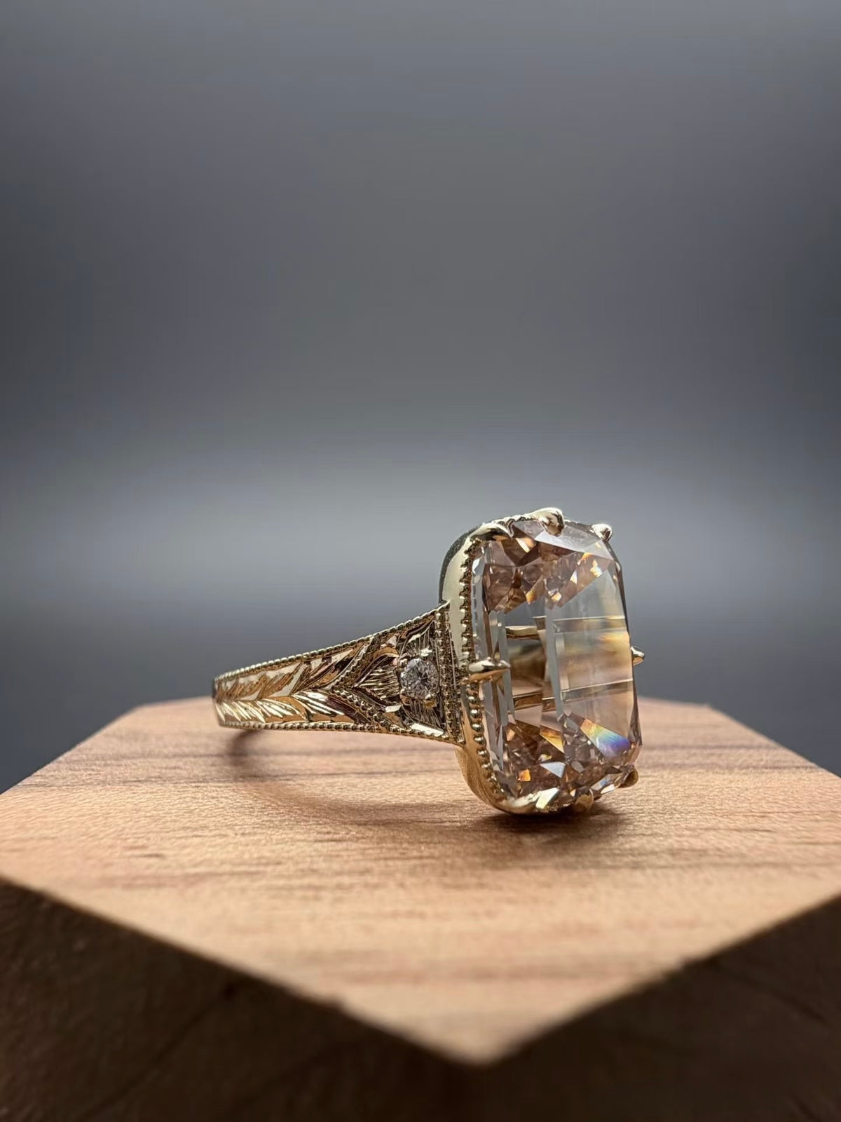Three-quarter view of champagne elongated cushion lab-grown diamond ring in yellow gold