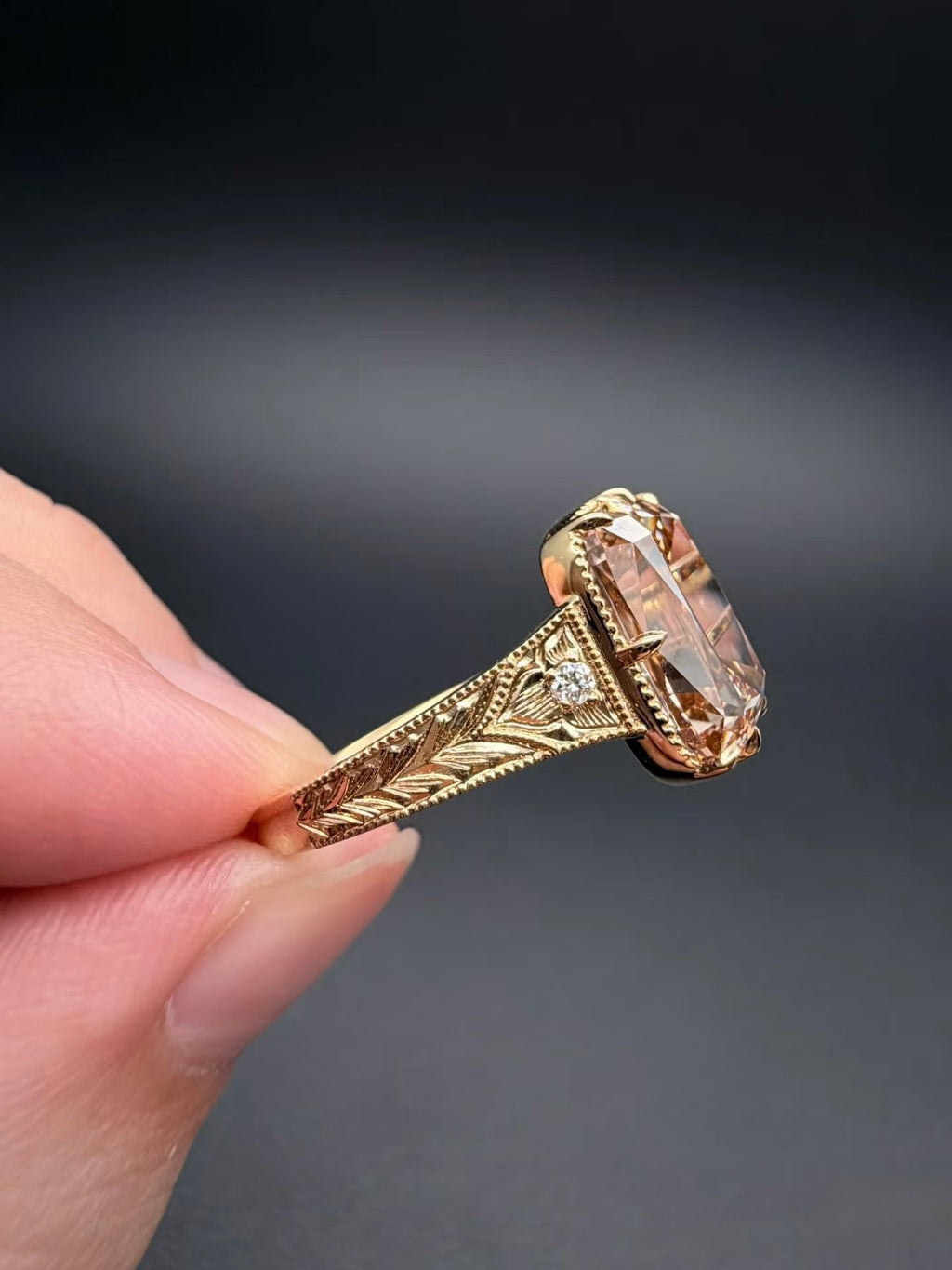 Engraved band side detail of champagne elongated cushion lab-grown diamond ring in yellow gold