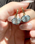 Georgian-inspired oval lab-grown diamond earrings with contrasting dark settings and yellow gold details