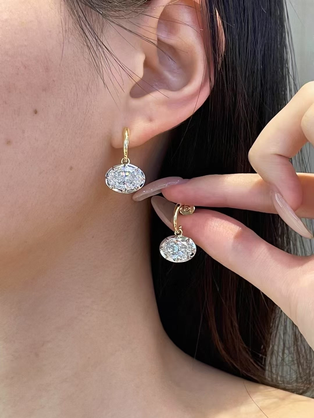 Oval lab-grown diamond earrings in 18K gold, shown worn