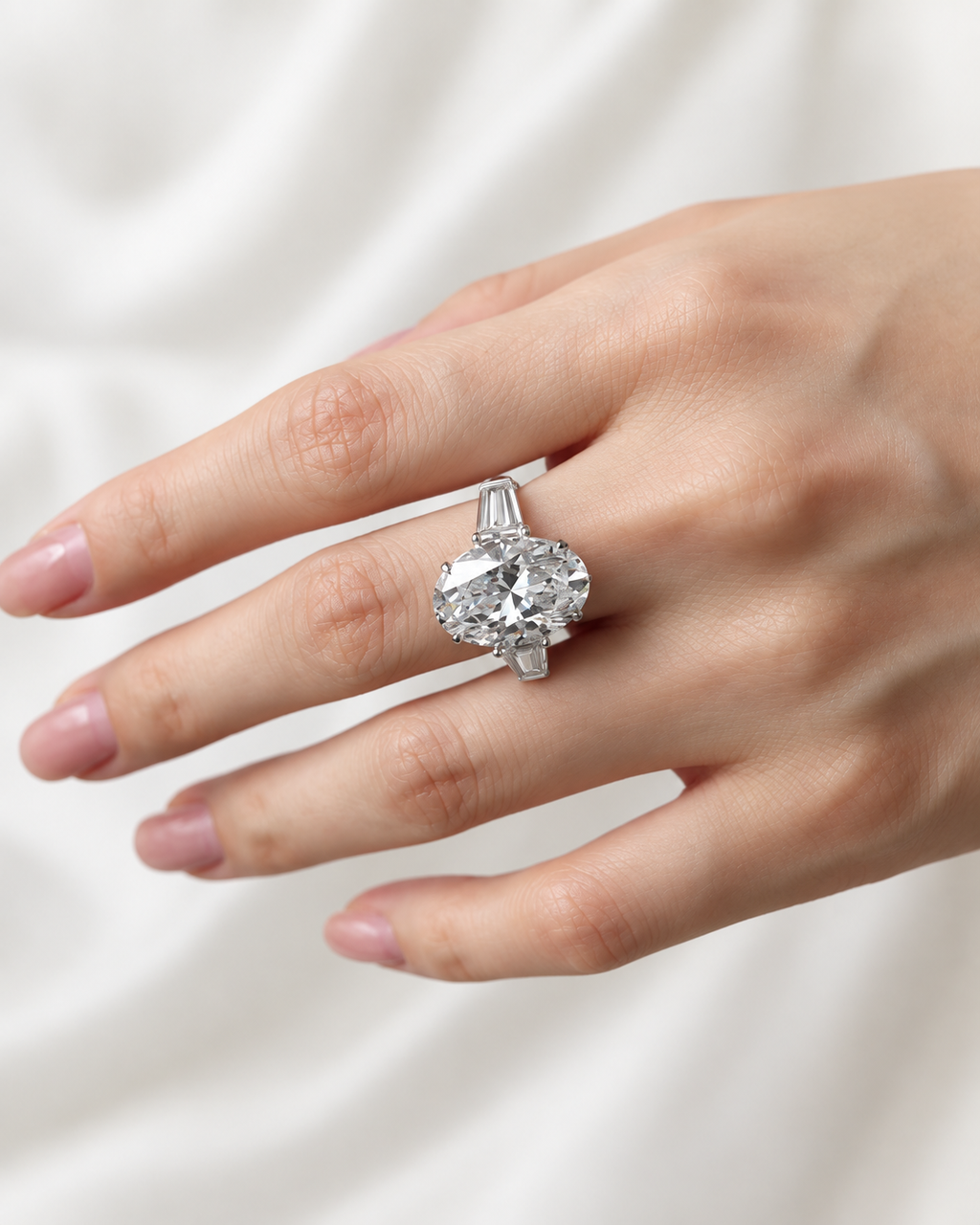 AI-enhanced styling image of oval center trilogy ring with tapered baguette side stones, view 3