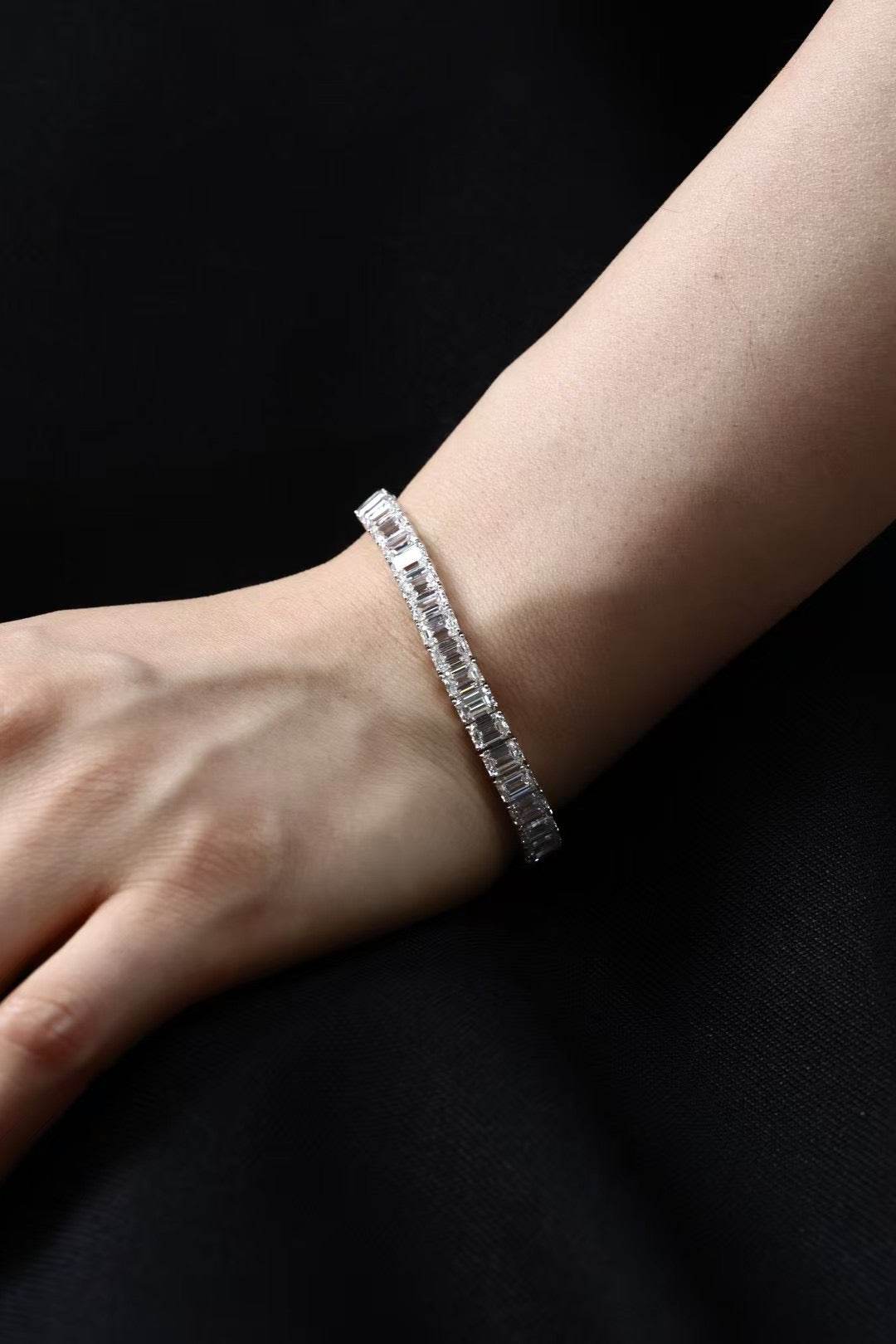 Emerald-cut lab-grown diamond tennis bracelet worn on wrist, view 1