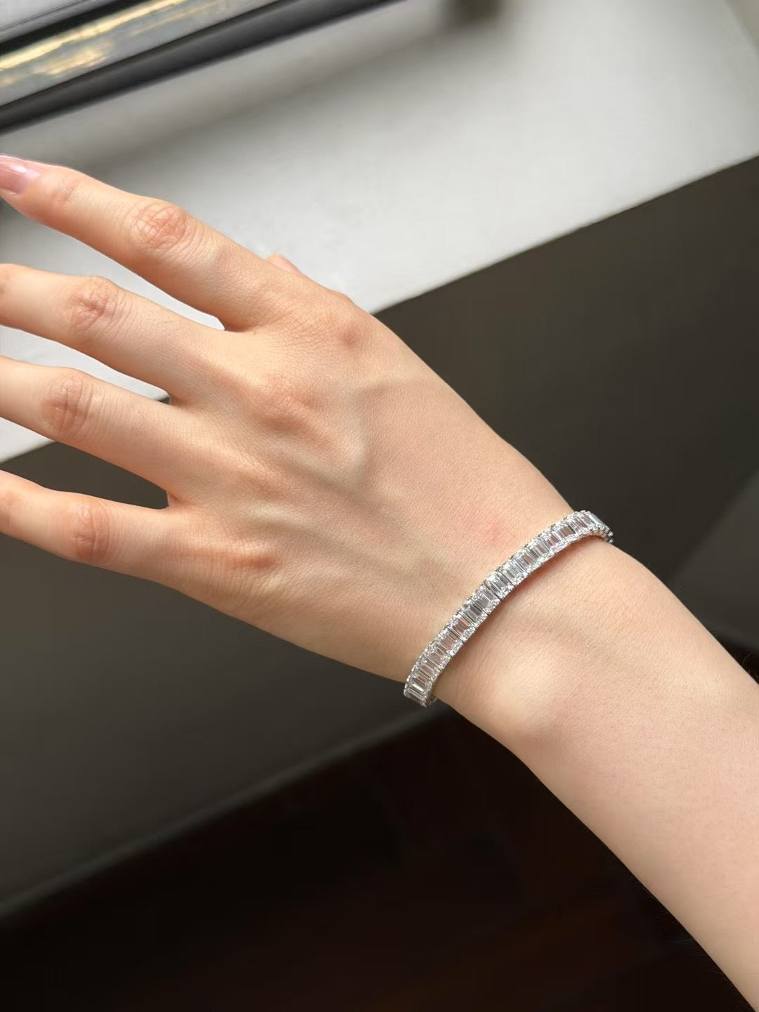 Emerald-cut lab-grown diamond tennis bracelet worn on wrist, view 3