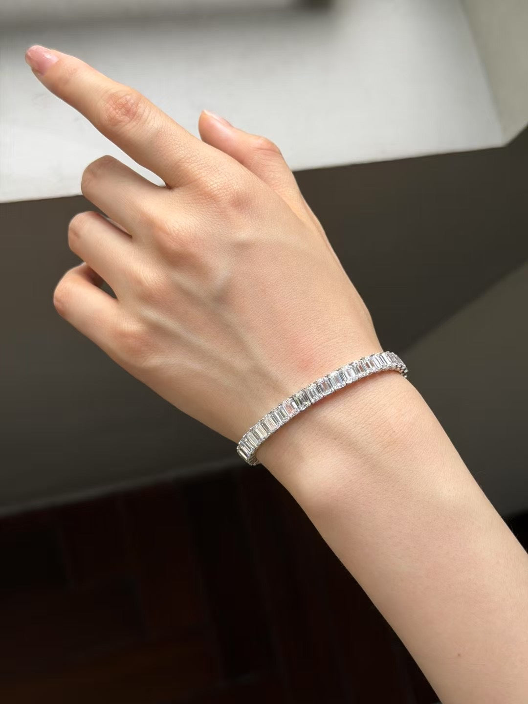 Emerald-cut lab-grown diamond tennis bracelet worn on wrist, view 4