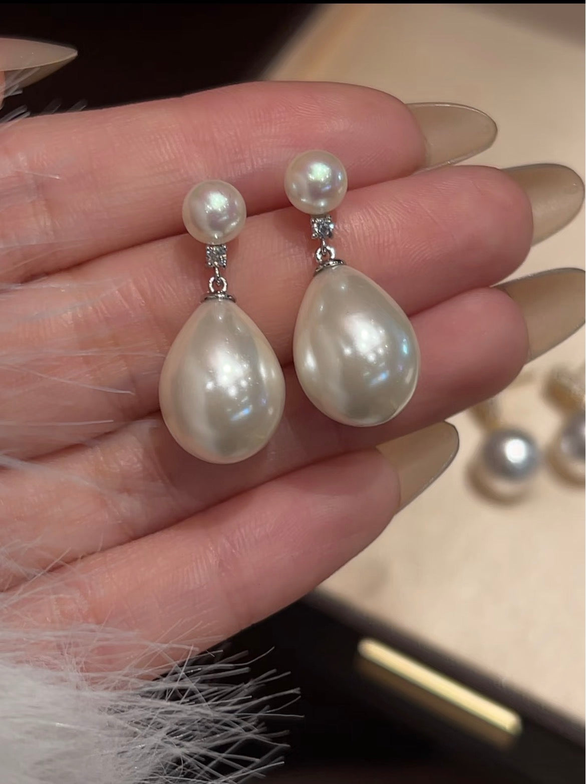 Freshwater pearl and natural diamond drop earrings close-up
