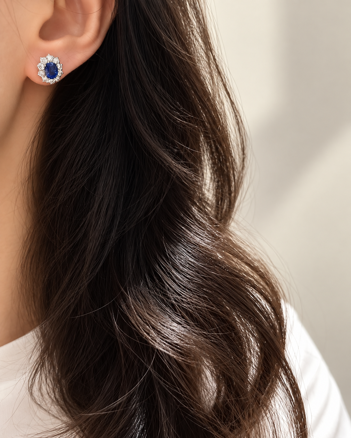 Natural sapphire platinum stud earring shown worn
