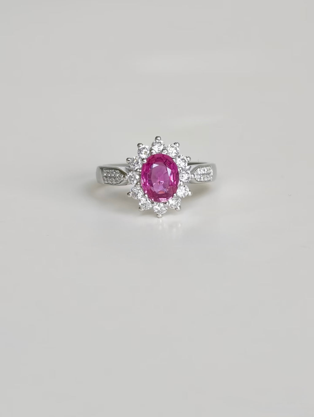 Pink sapphire ring with lab-grown diamond halo in 18K gold, front view