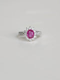 Pink sapphire ring with lab-grown diamond halo in 18K gold, front view
