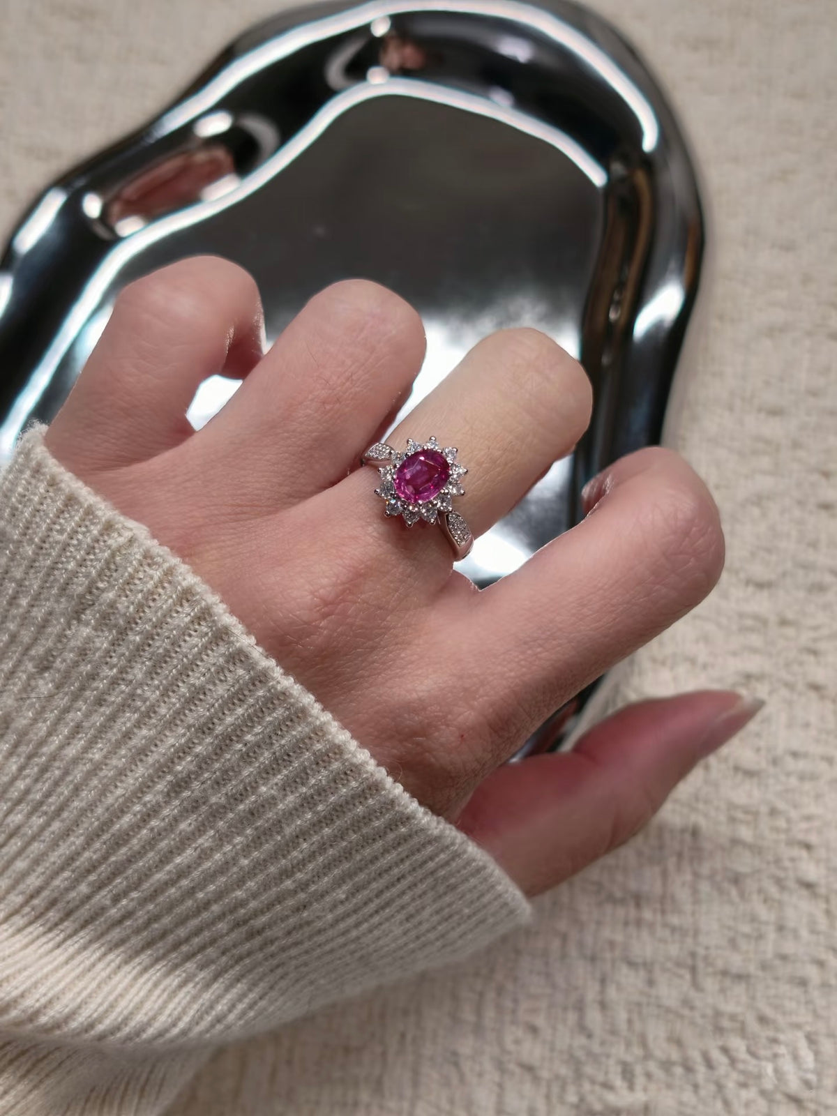 Pink sapphire halo ring shown worn