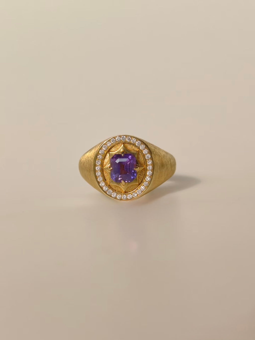 Unheated purple sapphire signet ring in brushed 18K yellow gold with natural diamond halo