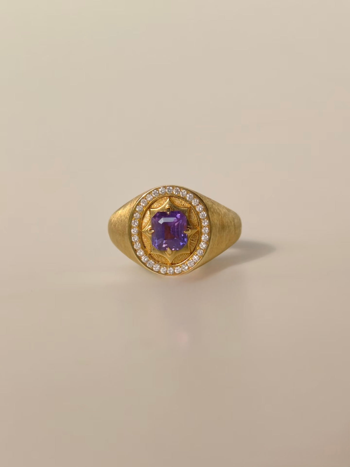 Unheated purple sapphire signet ring in brushed 18K yellow gold with natural diamond halo