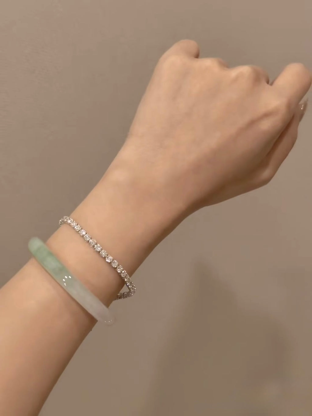 Lab-grown diamond tennis bracelet worn on wrist; bangle not included