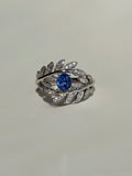 Royal blue sapphire ring with natural diamond leaf details in 18K gold