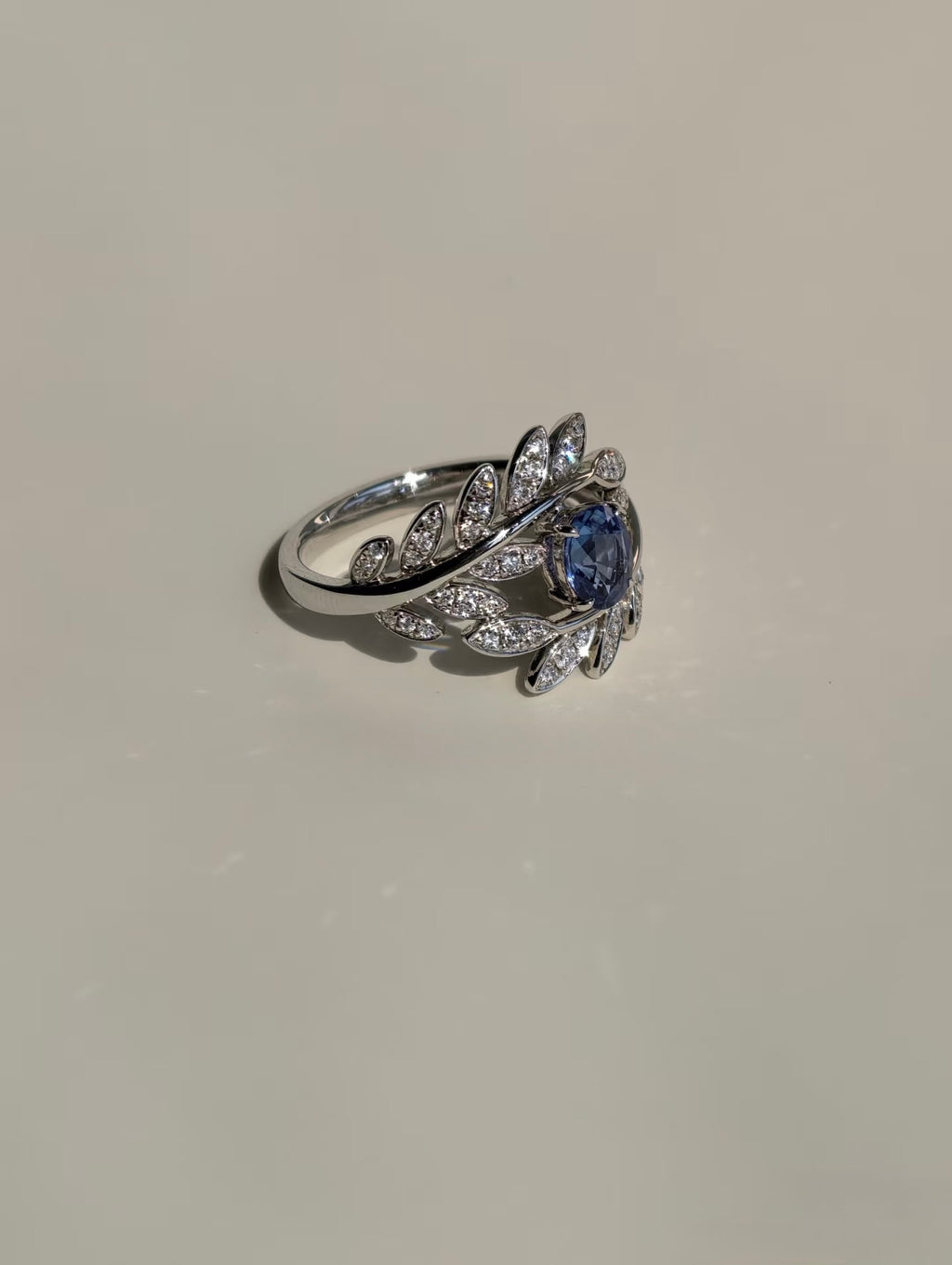 Side view of sapphire and natural diamond leaf ring