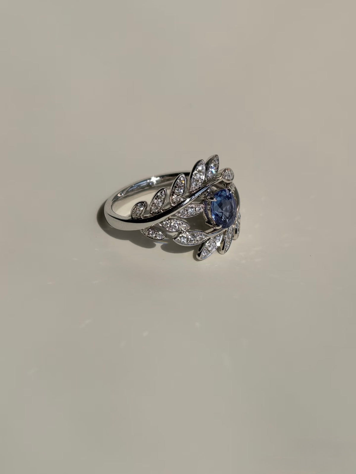 Side view of sapphire and natural diamond leaf ring
